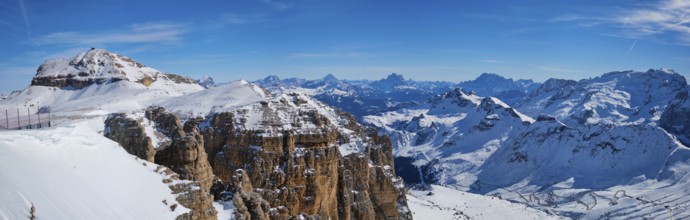 Panorama of a ski resort piste and Dolomites mountains in Italy from Passo Pordoi pass. Arabba,