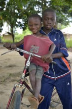 Two children with a bicycle, Nkala, Bandundu Province, Democratic Republic of the Congo