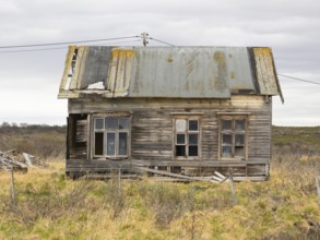 Derelict house on the shore of the Arctic Ocean, beside the town of Nesseby, May, Varangerfjord,