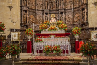 Magnificently decorated chancel of a church with richly ornamented wood carvings and colourful