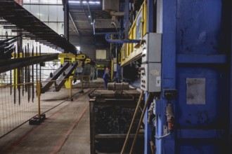 A worker stands at a boiler during a galvanising process. Taken during a press event at The Coatinc