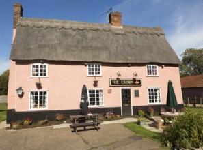 Thatched historic country pub building, The Crown, Bedfield, Suffolk, England, UK pink wash