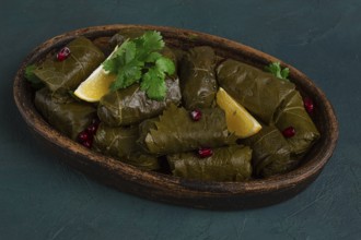 Dolma (Tolma) stuffed rolls, minced meat with rice, in grape leaves, top view, no people, close-up