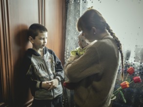 Nasar with his cousin Bogdana and baby Polia in their family home in Voloska Balakliia. The village