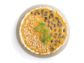 Traditional american sweet pumpkin pie decorated with mint, sesame and pumpkin seeds isolated