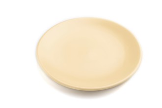 Empty beige ceramic plate isolated on white background. Side view, close up