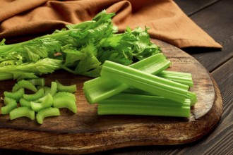 Fresh bunch of celery, top view, no people, on a dark background