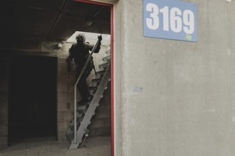 A soldier moves during a simulated house-to-house battle, taken as part of a Bundeswehr exercise