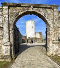 View through historic castle gate to old tower Castle tower of castle ruins Reifferscheid Castle,