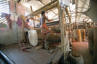 Indian workers in the weaving mill of the Labourers Coir Mats and Mattings Cooperation, coir mat