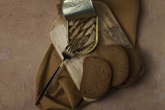 Sprats in butter, with black bread, canned smoked fish, open, close-up, top view, no people