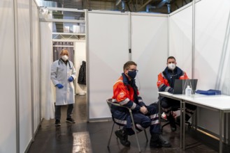 Vaccination team, vaccination doctor and helpers at the test run in the vaccination centre for the