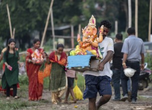 Devotees carries the Ganesha idol to immerse in the Brahmaputra river, during Ganesh Chaturthi