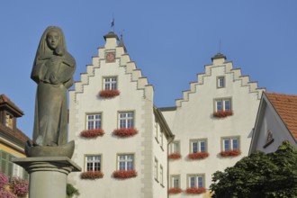 Madonna figure at the fountain and historic gate castle with stepped gable, town gate, town tower,