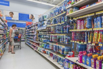 Woman shopping on oral hygiene isle at Walmart shopping center in Biloxi, Mississippi, USA, North