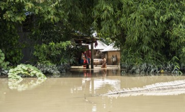 Morigaon, India. 4 July 2024. Residents in their flooded house, in a flood affected village in