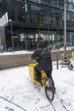 Winter in Frankfurt, DHL bicycle courier in the banking district, Hesse, Germany, Europe