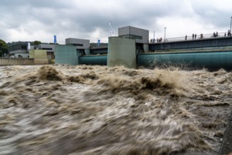 Weir of the Lake Baldeney in Essen, the masses of water roar through the open weirs, high water on