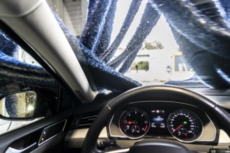 Car in an automatic car wash, car wash tunnel, drying, with hot air and rotating textile cloths