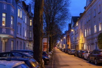 Residential street, many apartment buildings in a residential neighbourhood, evening, lantern