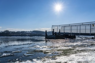 Winter in the Ruhr area, Lake Baldeney, snow-covered, partly frozen lake, shore, pier Strandbad,