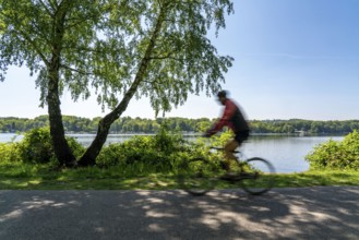 Cycling along the Ruhr, lakeside path on Lake Baldeney in Essen, North Rhine-Westphalia, Germany,