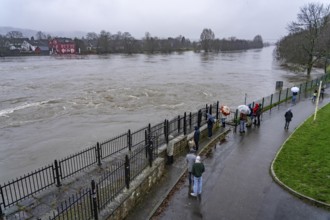 Spectators at high water on the Ruhr, here near Essen-Kettwig, below the weir of the Ruhr reservoir