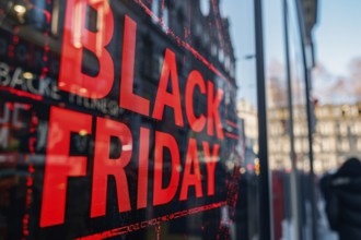 Black advertisement sign with red text 'Black Friday' in shopping window. Generative AI, AI