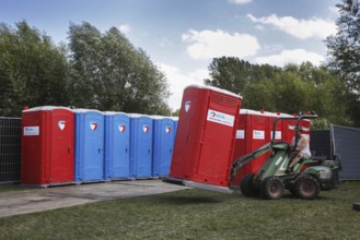 Placement of rows of colourful portable toilets at outdoor event