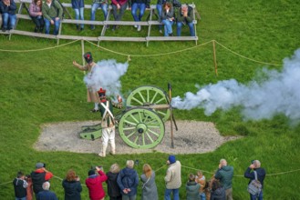 Tourists watching Napoleonic war reenactors firing cannon at the Domain of the Waterloo 1815