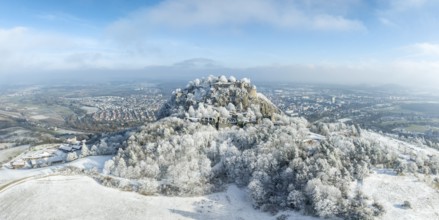 Aerial panorama of the snow-covered Hegau volcano Hohentwiel with Germany's largest castle ruins,