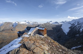 Snowy mountain landscape, mountain hut Ramolhaus in autumn with snow, in the evening light, view of