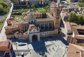 Aerial view of an impressive cathedral with adjoining entrance gate and surrounding historic