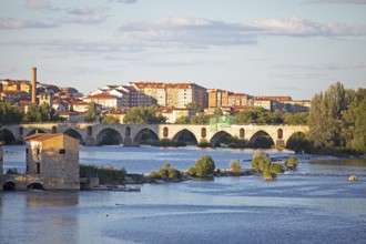 Town view Zamora, in front the Romanesque bridge Puente de Piedra over the river Rio Duero and the