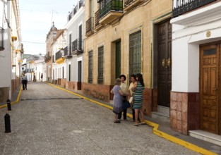 Group of women talking in the street, village of Alajar, Sierra de Aracena, Huelva province, Spain,