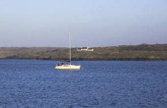 Yacht and farmhouse on Ringarogy Island from Baltimore, Roaringwater Bay, County Cork, Ireland,