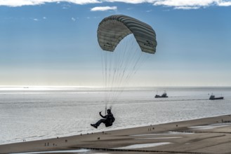 Paragliders along the dunes of Zoutelande, in Zeeland, South Holland, Netherlands