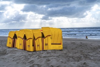 End of the season on the beach, dark storm clouds, choppy sea, autumn on the North Sea in North