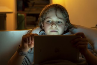 A boy plays computer games on a tablet PC