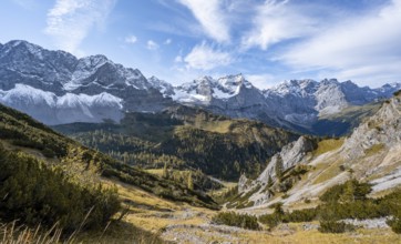 Mountain panorama with steep rocky peaks, yellow-coloured larches in autumn, view of Laliderspitze,