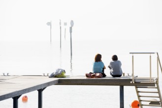 Two woman on a jetty, Immenstaad, Lake Constance, Baden-Württemberg, Germany, Europe