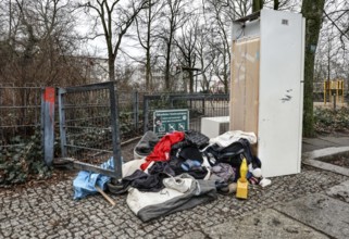 Clothing, a warning light and a refrigerator block the entrance to a public playground, illegal