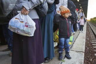 Syrian refugees arrive at Schönefeld station on a special train. They are then taken by bus to