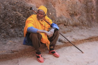 Rock churches of Lalibela, pilgrim sitting in front of a rock church, Ethiopia, Africa