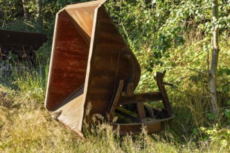 Old dilapidated rusty wagons of a light railway in an abandoned quarry, West Lusatia, Saxony,