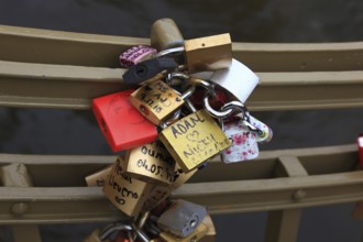 Lover's lock on a railing, love lock is a padlock which, according to custom, is attached to