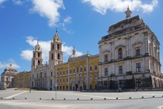 Spacious square in front of a magnificent baroque palace with towers under a blue sky, National