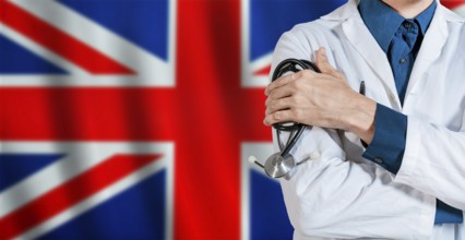 Doctor with stethoscope on UK flag. Male Doctor holding stethoscope on British flag