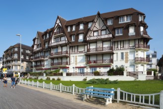 Large half-timbered house with well-kept garden on a promenade with blue bench, Trouville-sur-Mer,