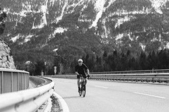 Road bike rider in spring between Lechtal and Tannheimer Tal in front of picturesque scenery of the